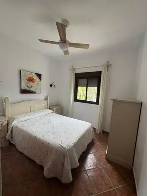 a bedroom with a bed and a ceiling fan at Viangel 2 in Conil de la Frontera
