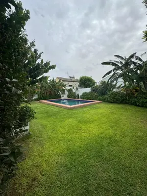 a yard with a swimming pool and a house at Viangel 2 in Conil de la Frontera