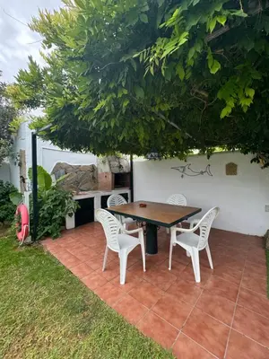 a table and chairs on a patio under a tree at Viangel 2 in Conil de la Frontera