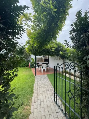 a gate to a garden with a table and chairs at Viangel 2 in Conil de la Frontera