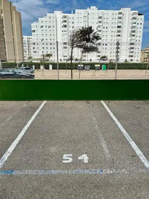 a parking lot in front of a large building at GATU Magavi Playa parking piscinas terraza 