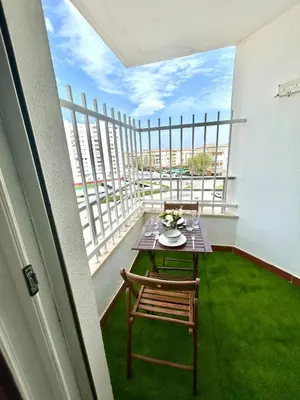 a table and chair on a balcony with a view at GATU Magavi Playa parking piscinas terraza 