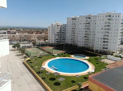 a view of a large building with a swimming pool at GATU Magavi Playa parking piscinas terraza 