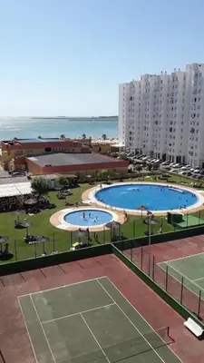 a view of a tennis court with two pools at GATU Magavi Playa parking piscinas terraza 