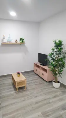 a living room with a tv and a coffee table at Apto G2 SANLUCAR DE BARRAMEDA in Sanlúcar de Barrameda