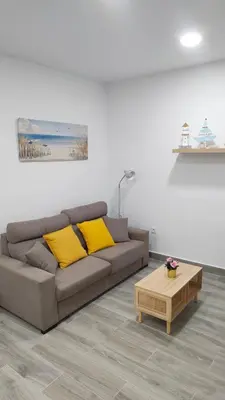 a living room with a couch and a coffee table at Apto G2 SANLUCAR DE BARRAMEDA in Sanlúcar de Barrameda