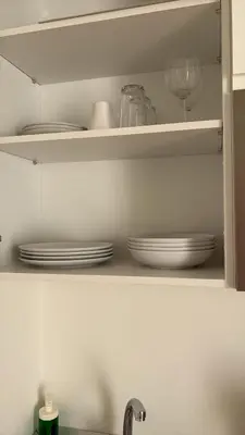 a kitchen shelf with plates and a wine glass at El Sueño in Jerez de la Frontera