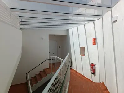 a staircase in a building with a fire hydrant at El Sueño in Jerez de la Frontera