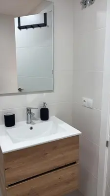 a bathroom with a white sink and a mirror at El Sueño in Jerez de la Frontera