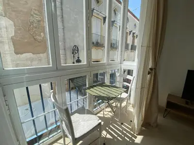 a view of a balcony with a table and chairs at Apartamentos Tartaneros 4 in Sanlúcar de Barrameda