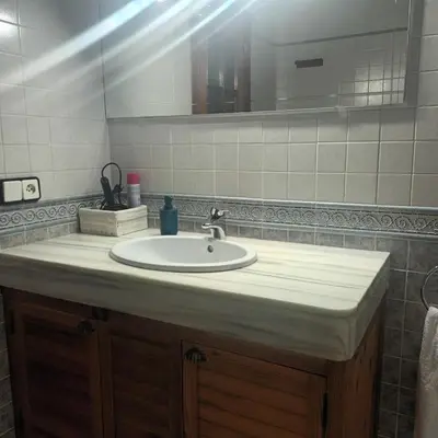 a bathroom with a sink and a mirror at Casa Rural MATEOS in El Puerto de Santa María