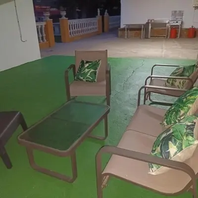 a group of chairs sitting on a green floor at Casa Rural MATEOS in El Puerto de Santa María