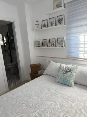 a bedroom with a bed with a pillow on it at Mi refugio azul in Cádiz