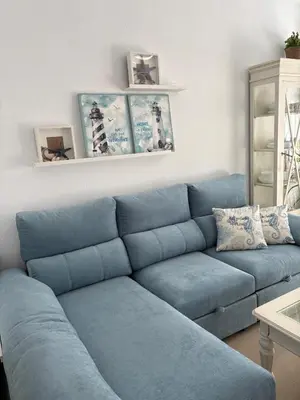 a blue couch in a living room at Mi refugio azul in Cádiz