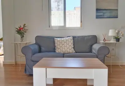 a living room with a couch and a coffee table at Apartamento Fuente de Los Naranjos in Jerez de la Frontera