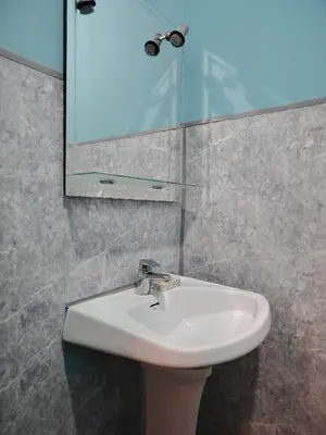a bathroom with a white sink and a mirror at Casa adosada con patio in Jerez