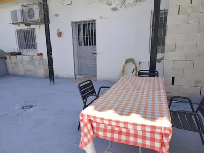a table with a red and white checkered table cloth at Casa adosada con patio in Jerez