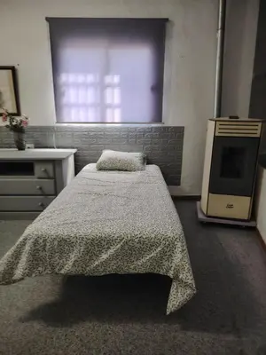 a bedroom with a bed and a television in it at Casa adosada con patio in Jerez