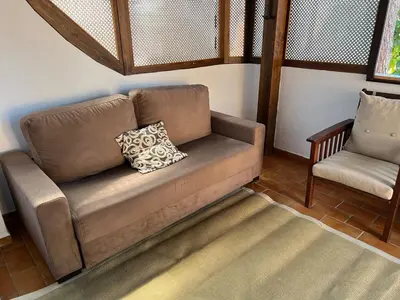 a couch and a chair in a living room at La caracola in Novo Sancti Petri
