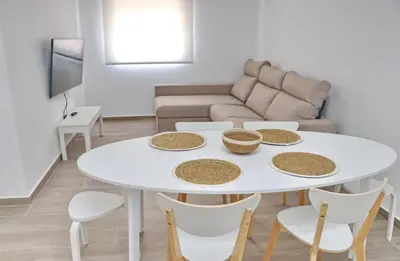 a living room with a white table and chairs at Chalet Ruperto III in Conil de la Frontera