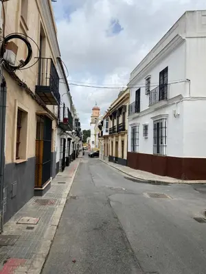 an empty street in a city with buildings at Casa Lotte, centro histórico,AC, garaje, wifi in Sanlúcar de Barrameda