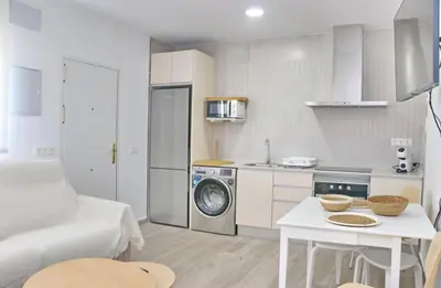 a small kitchen with a washing machine in a room at Chalet Ruperto II in Conil de la Frontera
