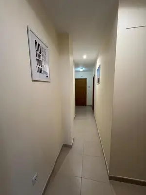 a long hallway with a sign on the wall at Apartamento turístico in Chiclana de la Frontera
