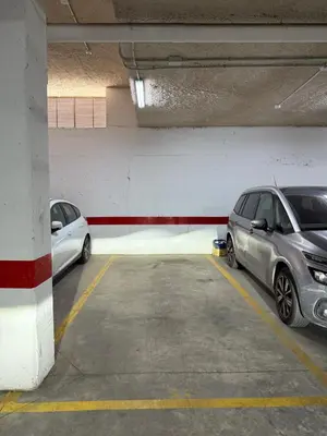 two cars are parked in a parking garage at Apartamento turístico in Chiclana de la Frontera
