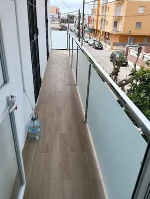 a balcony with a water bottle on the floor at Apartamento de lujo en Playa de Regla in Chipiona