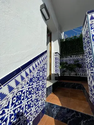 a room with blue and white tiles on the wall at Apartamento el Ancla in El Puerto de Santa María
