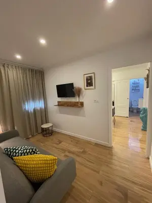 a living room with a couch and a flat screen tv at Apartamento el Ancla in El Puerto de Santa María