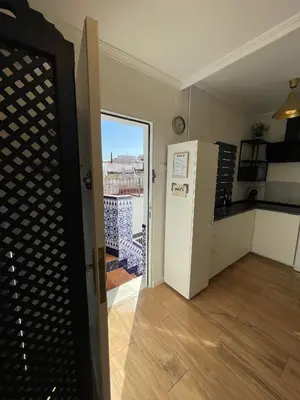 a kitchen with a refrigerator and a view of a city at Apartamento el Ancla in El Puerto de Santa María