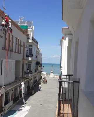 a view of the ocean from the balcony of a building at Cruz Del MAR in Chipiona