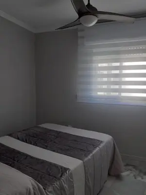 a bedroom with a bed and a ceiling fan at Cruz Del MAR in Chipiona