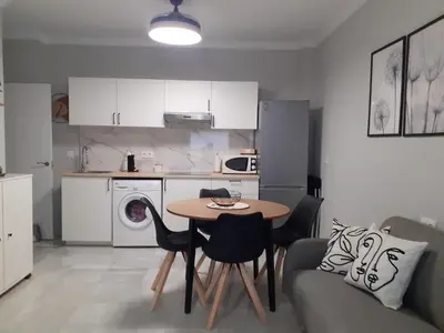 a kitchen with a table and chairs in a room at Cruz Del MAR in Chipiona