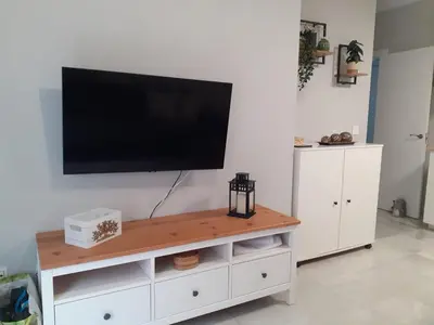 a flat screen tv on a white entertainment center at Cruz Del MAR in Chipiona