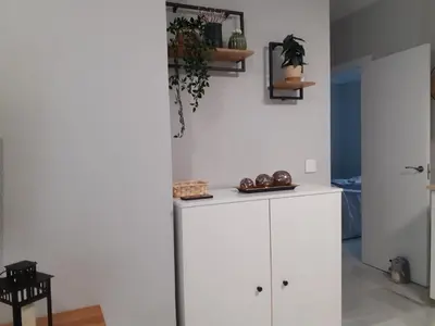a kitchen with a white cabinet and a table at Cruz Del MAR in Chipiona