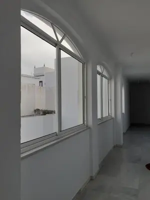 an empty room with three windows in a building at Cruz Del MAR in Chipiona