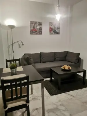 a living room with a couch and a table at Apartamento Edificio Carruaje in Jerez de la Frontera