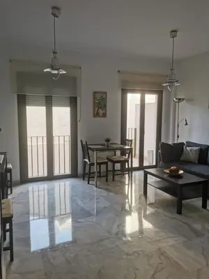 a living room with a couch and a table at Apartamento Edificio Carruaje in Jerez de la Frontera