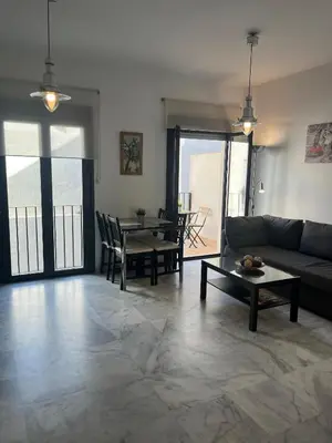 a living room with a couch and a table at Apartamento Edificio Carruaje in Jerez de la Frontera