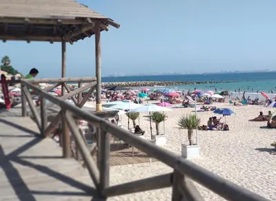 a beach with a lot of people on it at Playa Fuentebravia apartament in El Puerto de Santa María