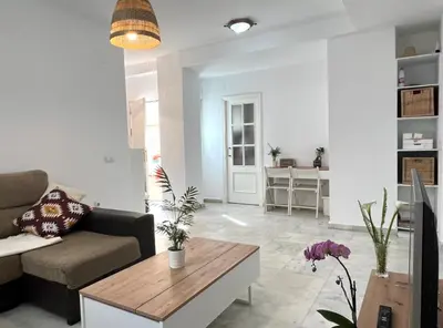 a living room with a couch and a table at Playa Fuentebravia apartament in El Puerto de Santa María