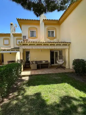 a house with a patio with a couch in the yard at Chalet adosado en Novo Sancti Petri in Cádiz