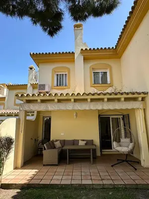 a house with a patio in front of it at Chalet adosado en Novo Sancti Petri in Cádiz