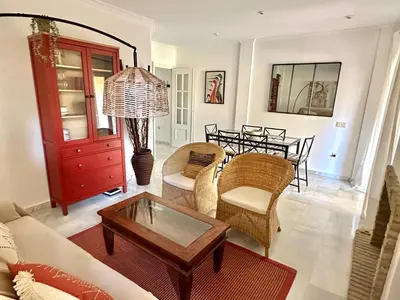 a living room with a couch and a table at Chalet adosado en Novo Sancti Petri in Cádiz