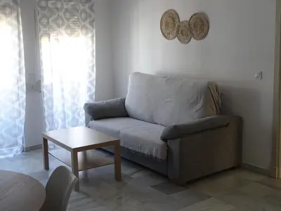 a living room with a couch and a table at Apartamento Capillera 9 in El Puerto de Santa María