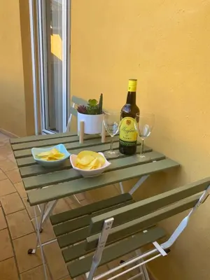 a table with a bottle of wine and glasses at Apartamento Capillera 9 in El Puerto de Santa María