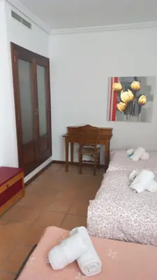 a living room with two beds and a table at Marina Sur in San Fernando