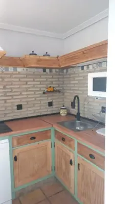 a kitchen with wooden cabinets and a sink at Marina Sur in San Fernando